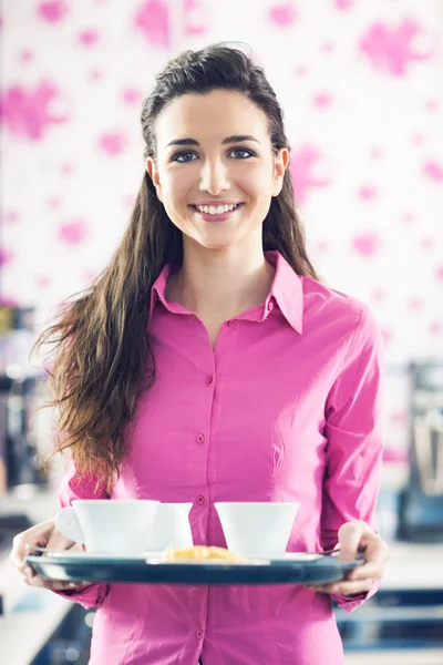 Waitress serving coffee at bar Stock Photo