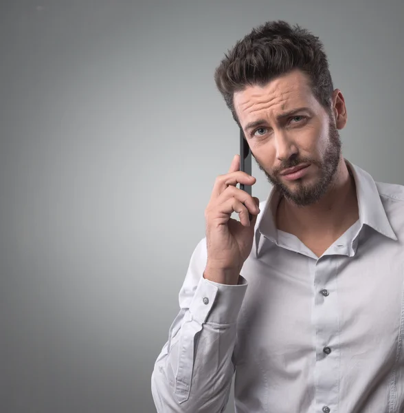 Disappointed man on the phone — Stock Photo, Image
