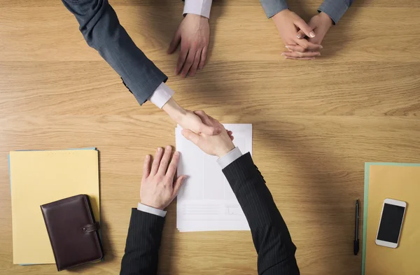 Business people handshaking after signing an agreement — Stock Photo, Image