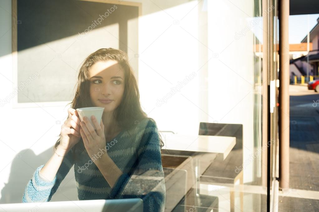 Girl at bar having coffee break