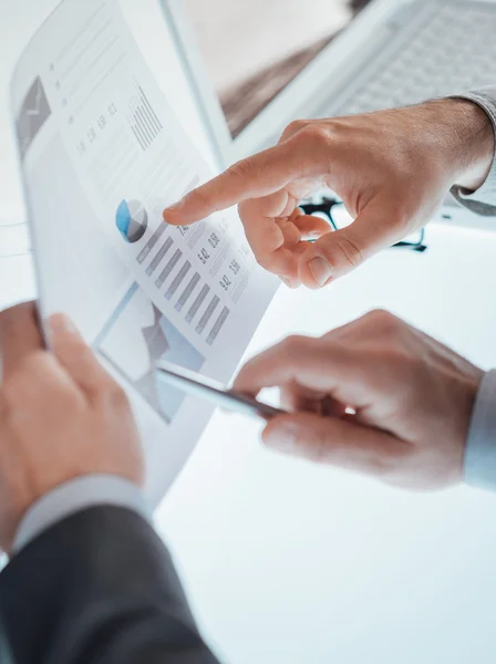 Businessmen examining a financial report — Stock Photo, Image