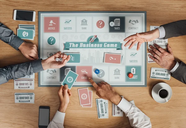 People playing a business board game