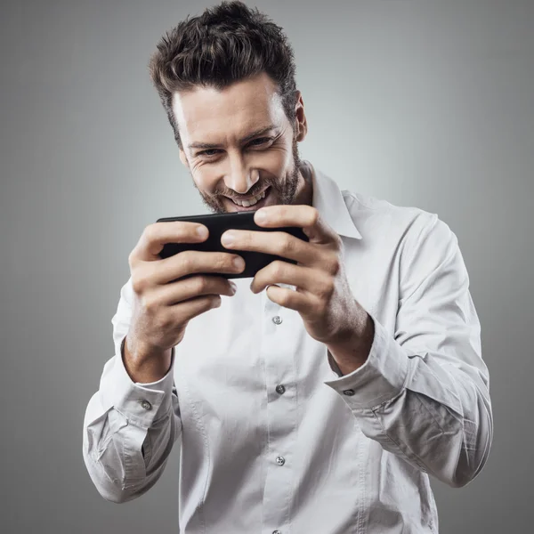 Uomo che gioca con lo smartphone — Foto Stock