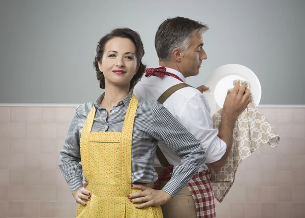 Oman watching her husband in apron — 스톡 사진