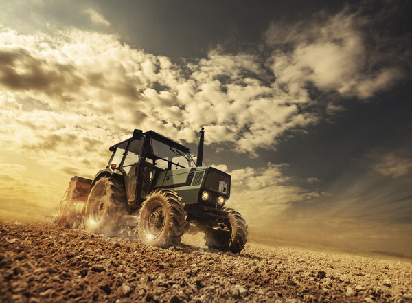 Farmer in the field driving a tractor