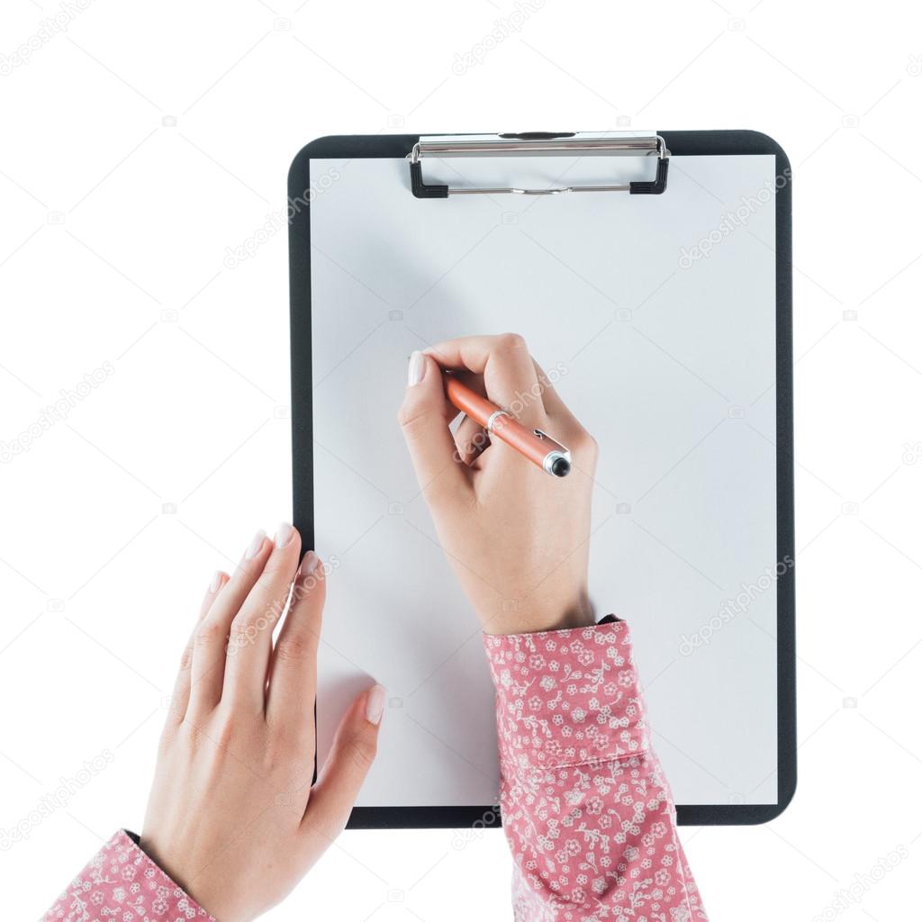 Woman writing on a clipboard