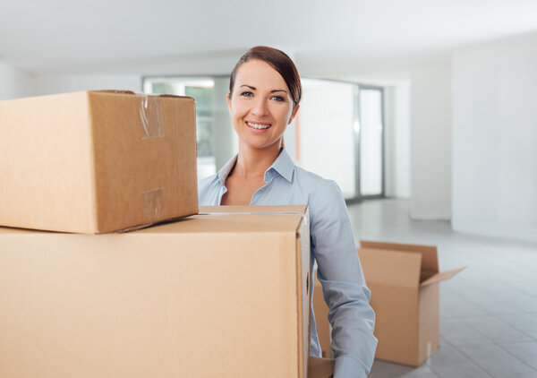 Young woman carrying carton boxes