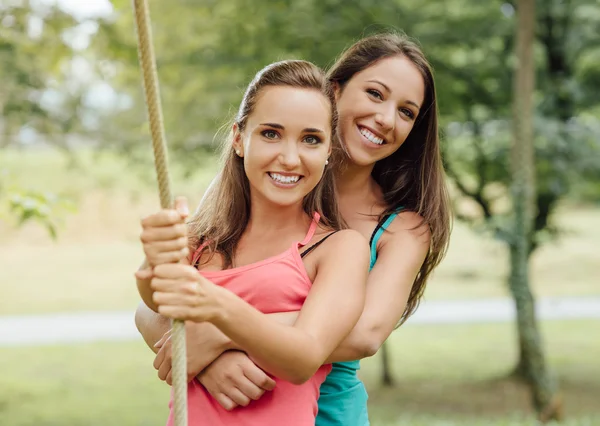 Cheerful girls in  the park hugging — Stock Photo, Image