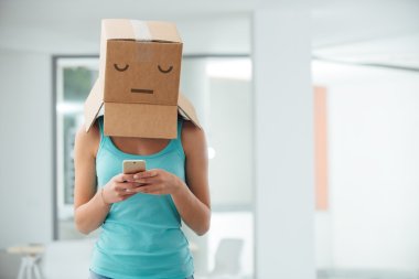 girl with a box on her head texting clipart