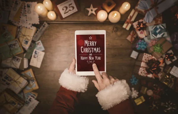 Santa Claus using a tablet — Stock Photo, Image