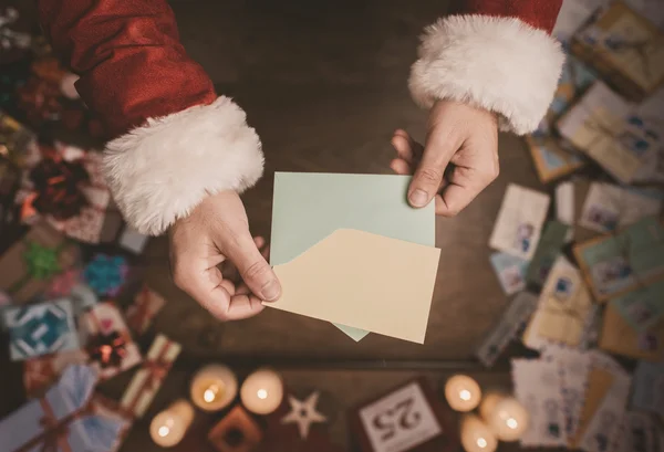 Santa Claus opening a Christmas letter — Stock Photo, Image