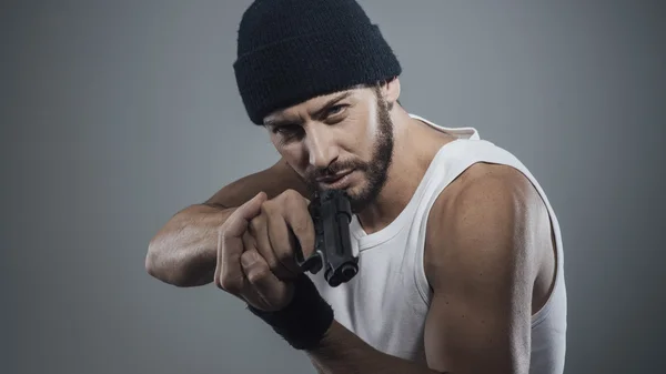 Criminal holding a gun — Stock Photo, Image