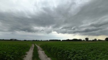 storm cloud aproaching over fields - timelapse