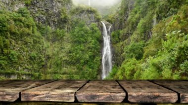 Empty wooden table footage with jungle waterfall in background