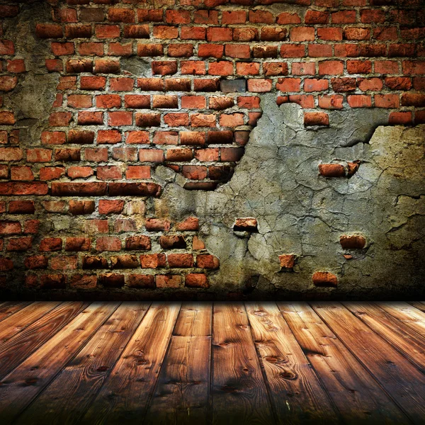 Trä golv och tegel vägg — Stockfoto