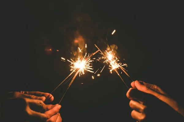 Closeup Image Hands Holding Sparklers Celebrate Night Time — Stock Photo, Image