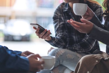 İnsanlar telefon eder, konuşur ve kahve içerler.