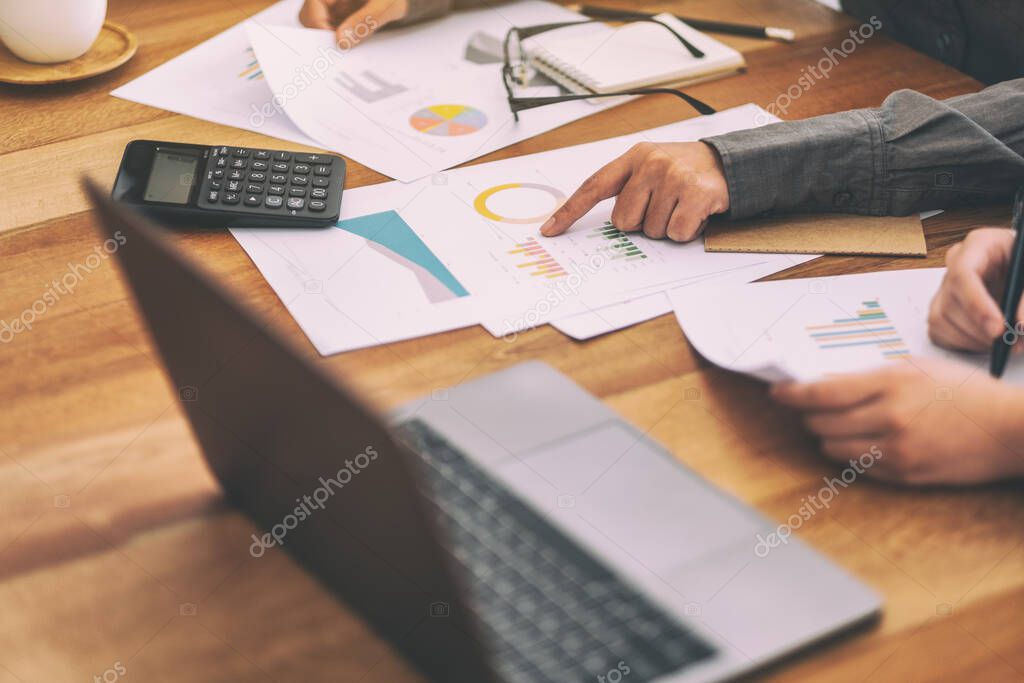 Businessman pointing finger at paperwork while discussing business together in a meeting