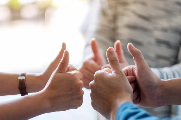 People making thumb up sign in circle