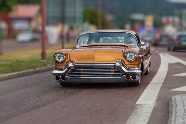RATTVIC, SWEDEN - Jul 27, 2021: Stylish orange vintage Cadillac DeVille. Retro car.