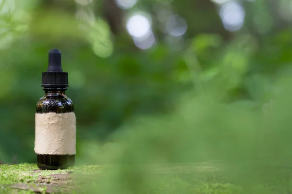 Herbal brown bottle on moss. Bokeh , blur background provides, copyspace. Natural Redium