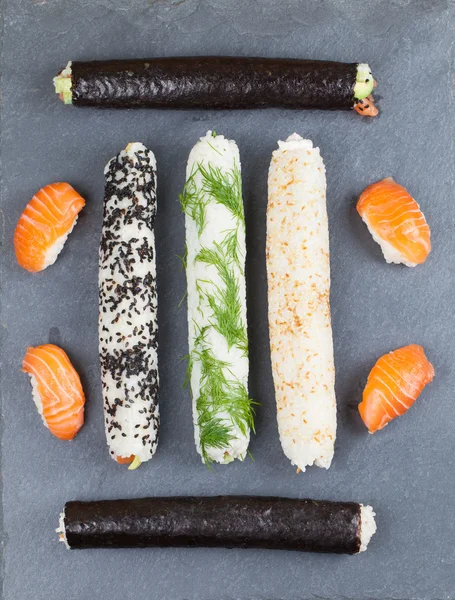 Homemade sushi rolls on a slate board — Stock Photo, Image