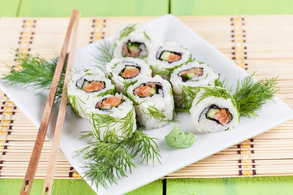 Sushi Uramaki con cetriolo, salmone crudo e aneto Foto Stock