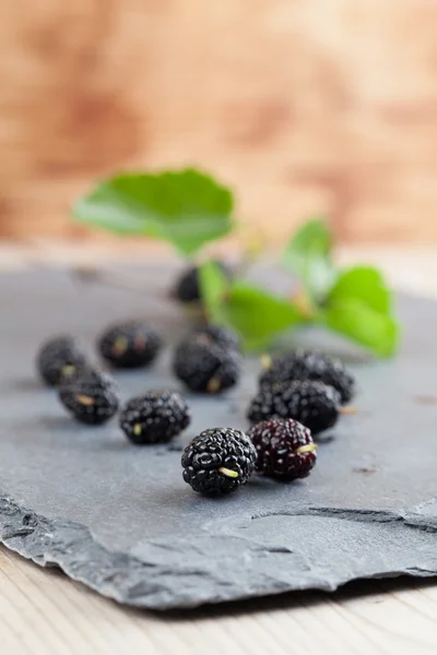 Mulberries on a slate board — Stock Photo, Image