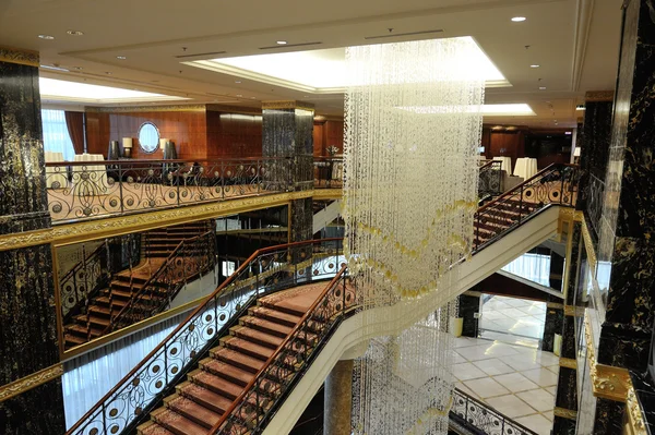 Hall, stairs and a large chandelier in hotel Lotte — Stock Photo, Image