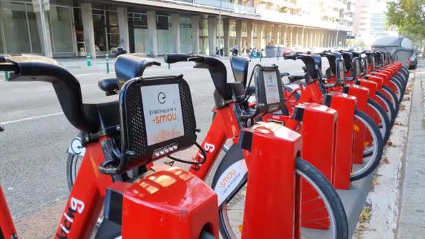 Barcellona, Spagna. Novembre 2020: Linea di biciclette rosse in un portabici, disponibile per il noleggio per le strade di Barcellona — Video Stock