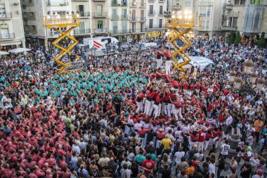 Reus, Spain - October 03, 2009: Castells Performance, a castell is a human tower built traditionally in festivals within Catalonia. This is also on the UNESCO Intangible Cultural Heritage of Humanity clipart