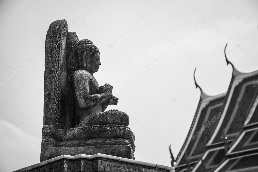 Sitting buddha stne statue. Black and white image