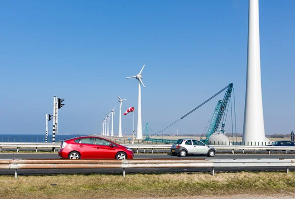 Dutch highway with cars along construction site wind turbines — Stock Photo, Image