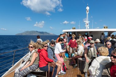 Cruise ship with tourists visiting the Aeolian Islands at Sicily, Italy clipart
