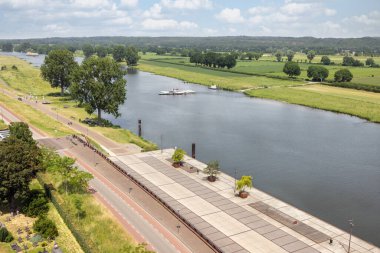 Aerial view Dutch village Cuijk along river Meuse clipart