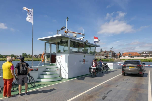 Bikers and car at ferry crossing Dutch river Meuse — Stok fotoğraf