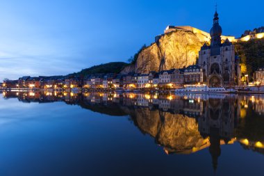 Cityscape of Dinant at night along the river Meuse, Belgium clipart