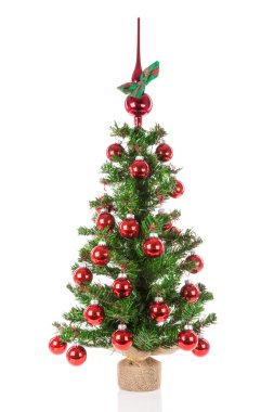 Decorated Christmas tree with peak balls over a white background clipart