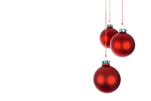 Three hanging Christmas balls at a white background — Stock Photo, Image