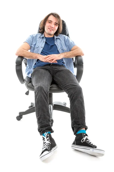 Frontview of lazy man sitting stretched out in an armchair — Stock Photo, Image