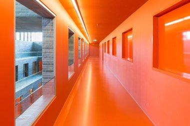 Interior modern building with several floors and orange painted passages clipart