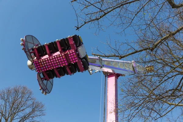 Fairground attraction with spinning seats — Stock Photo, Image