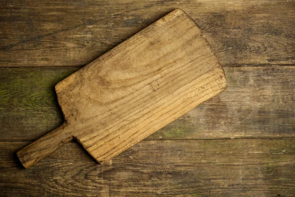 Rustic kitchen board on wooden background — Stock Photo, Image