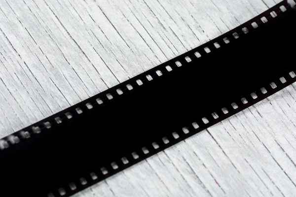 Photographic film on wooden background. Top view
