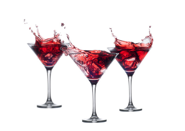 full martini glass with red cocktail fnd splashes isolated on white