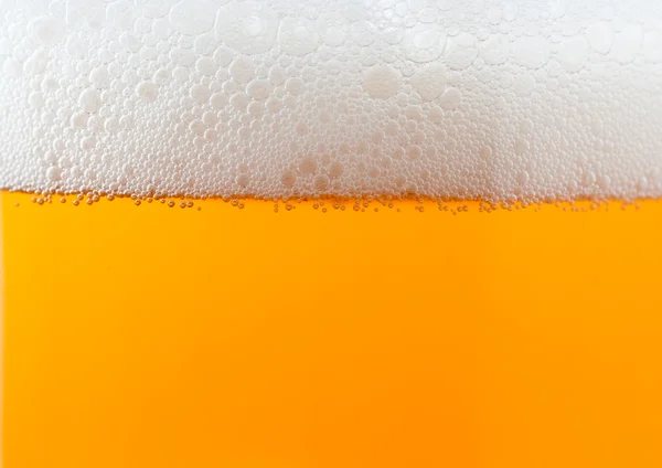 Light bier achtergrond met schuim — Stockfoto