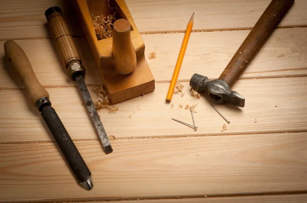Carpenter tools in pine wood table — Stock Photo, Image
