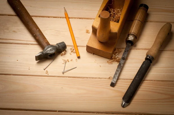 Carpenter tools in pine wood table — Stock Photo, Image