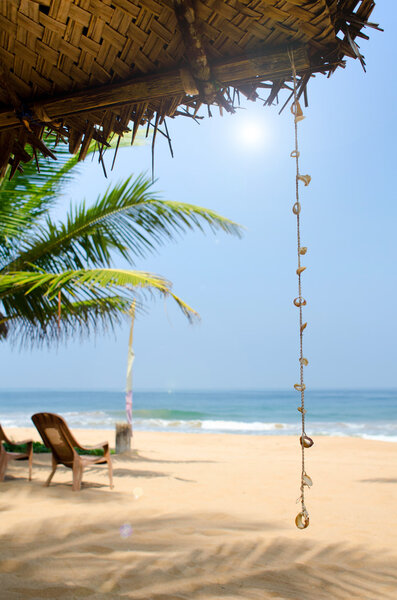 Untouched tropical beach with palms and fishing boats in Sri-Lanka