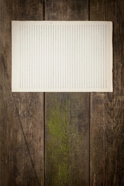 Old paper sheet on wooden background — Stock Photo, Image